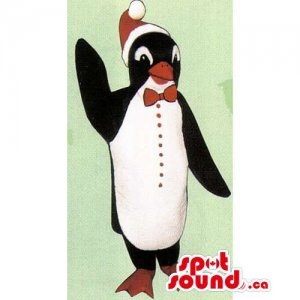 Cute Penguin Mascot Dressed In A Christmas Hat And A Bow Tie