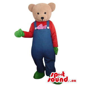Light Brown Teddy Bear Dressed In Blue Overalls And Green Gloves